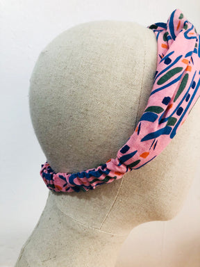 The Twist Headband in 'Hungry Bugs on Pink'