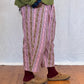 Person wearing a patterned trousers and  on a wooden floor. Humphries and Begg