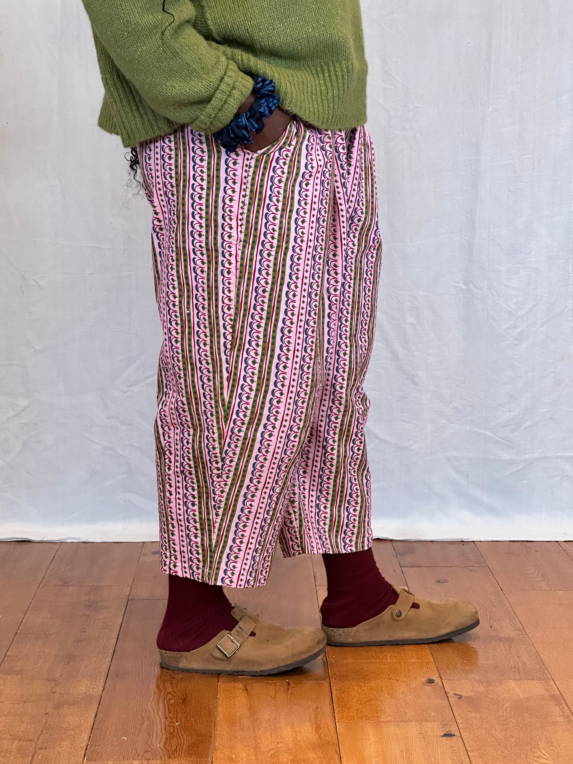 Person wearing a patterned trousers and  on a wooden floor. Humphries and Begg