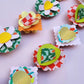 Colorful paper flower decorations on a white background