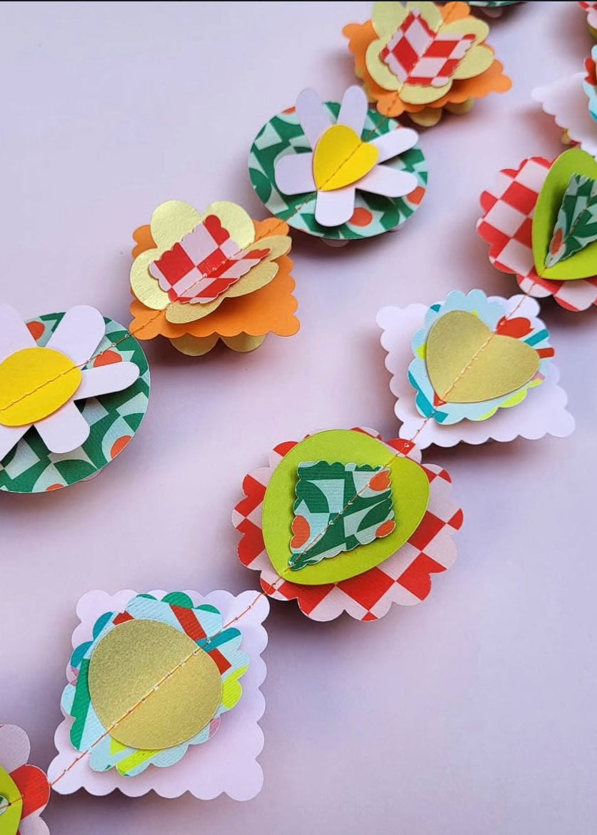 Colorful paper flower decorations on a white background