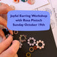 Handmade earrings being held with promotional text for a earring workshop.