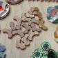 Collection of decorative ceramic pieces on a textured surface