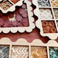 Floral earrings in a box with a display of various floral designs.
