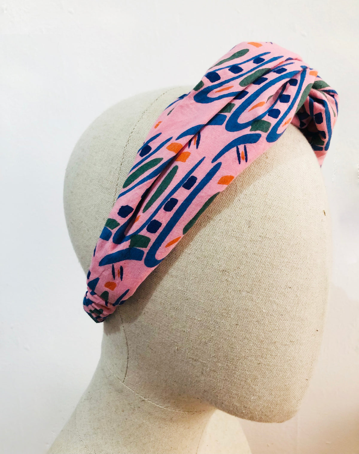 The Twist Headband in 'Hungry Bugs on Pink'